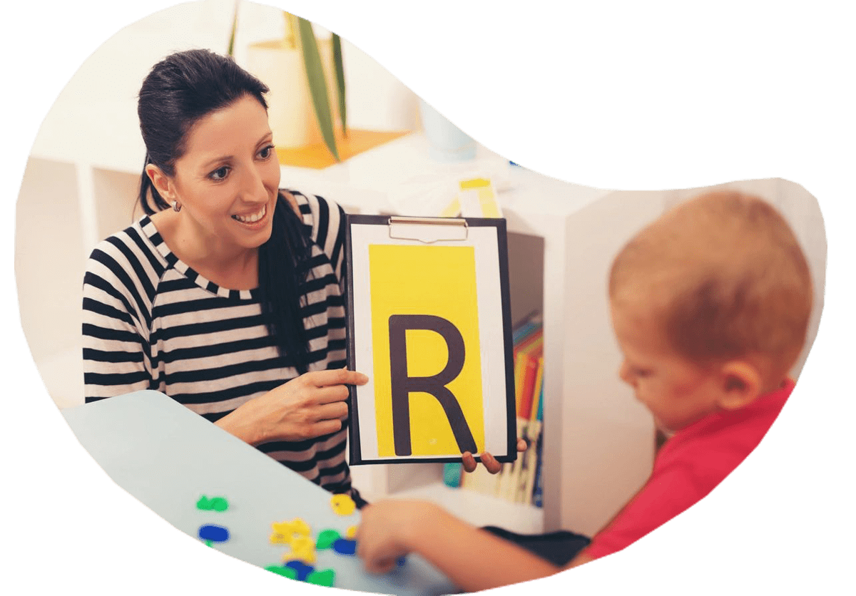 A woman and child are playing with letters.